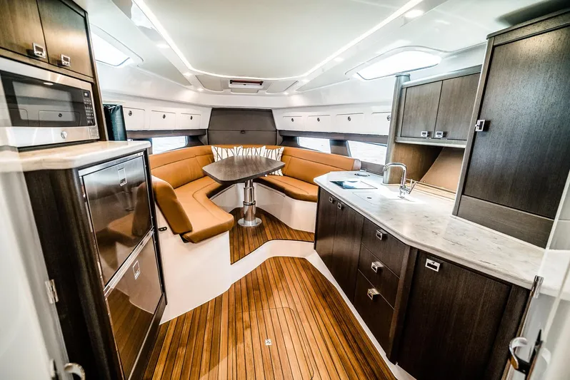  Yacht Photos Pics Manufacturer Provided Image: Luxurious interior of the 2023 Intrepid 438 Evolution yacht with modern kitchen and seating area.