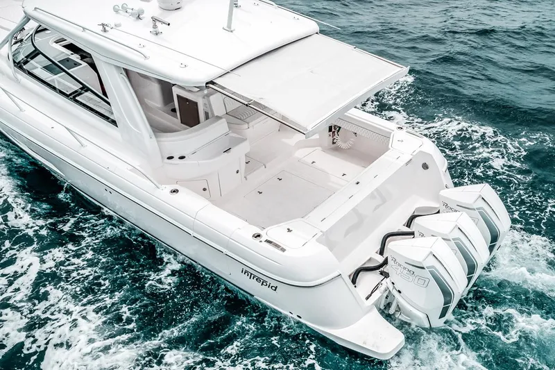  Yacht Photos Pics Manufacturer Provided Image: 2023 Intrepid 438 Evolution luxury yacht with triple outboard engines cruising on the ocean.
