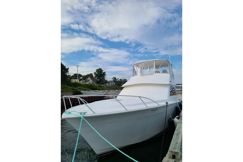 Black Gold Yacht Photos Pics 2006 Egg Harbor 50 Sport Yacht docked under a blue sky.