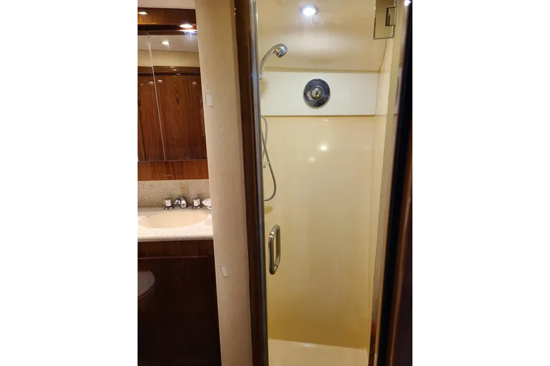 Black Gold Yacht Photos Pics Shower area in 2006 Egg Harbor 50 Sport Yacht with wooden cabinetry and modern fixtures.