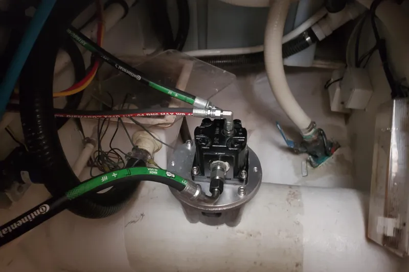 Black Gold Yacht Photos Pics Engine compartment of a 2006 Egg Harbor 50 Sport Yacht with visible hoses and components.