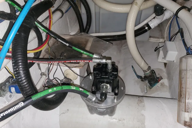 Black Gold Yacht Photos Pics Engine room of 2006 Egg Harbor 50 Sport Yacht with hoses and mechanical components.