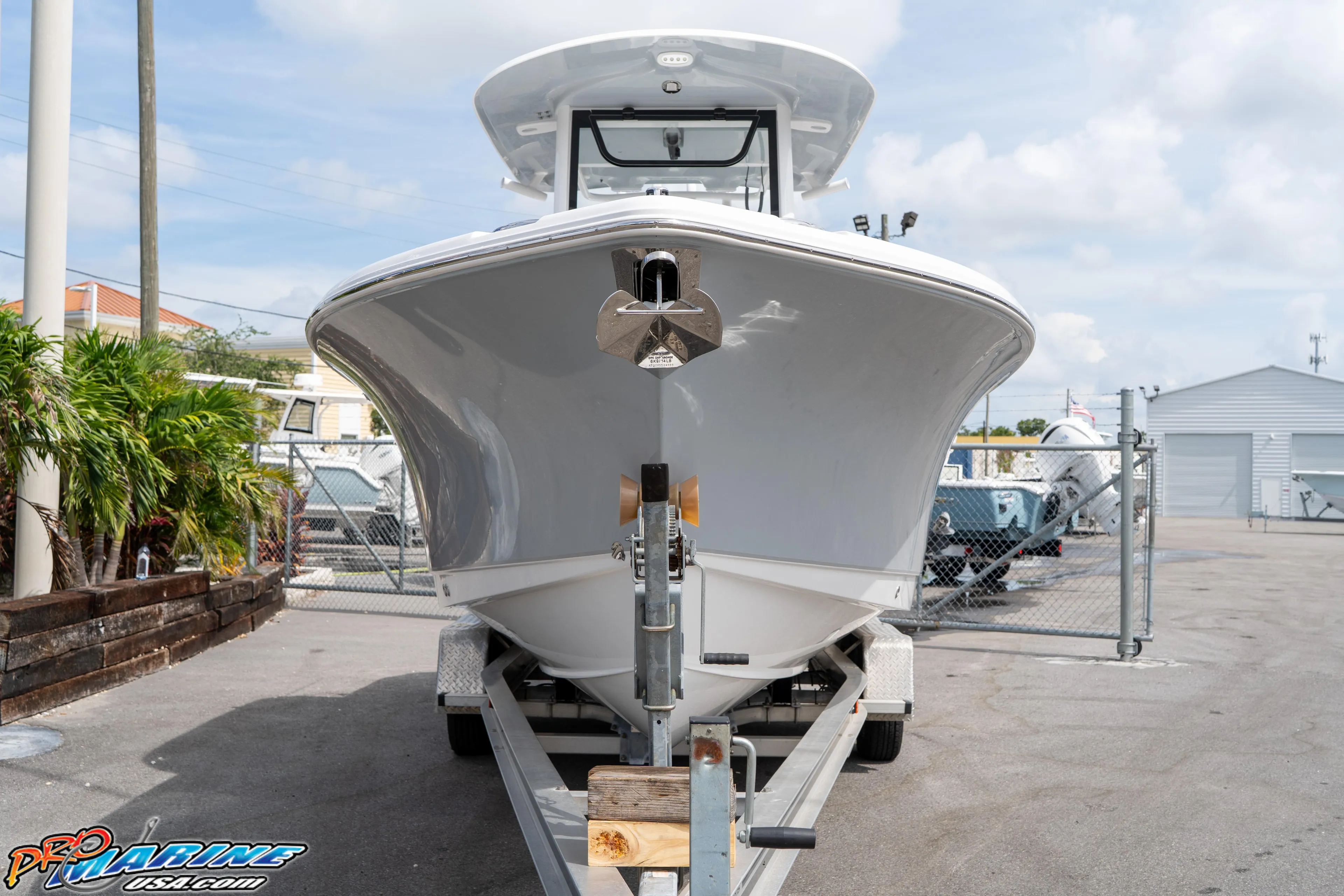 2026 Sea Hunt Ultra 255 SE boat on trailer in marina setting.
