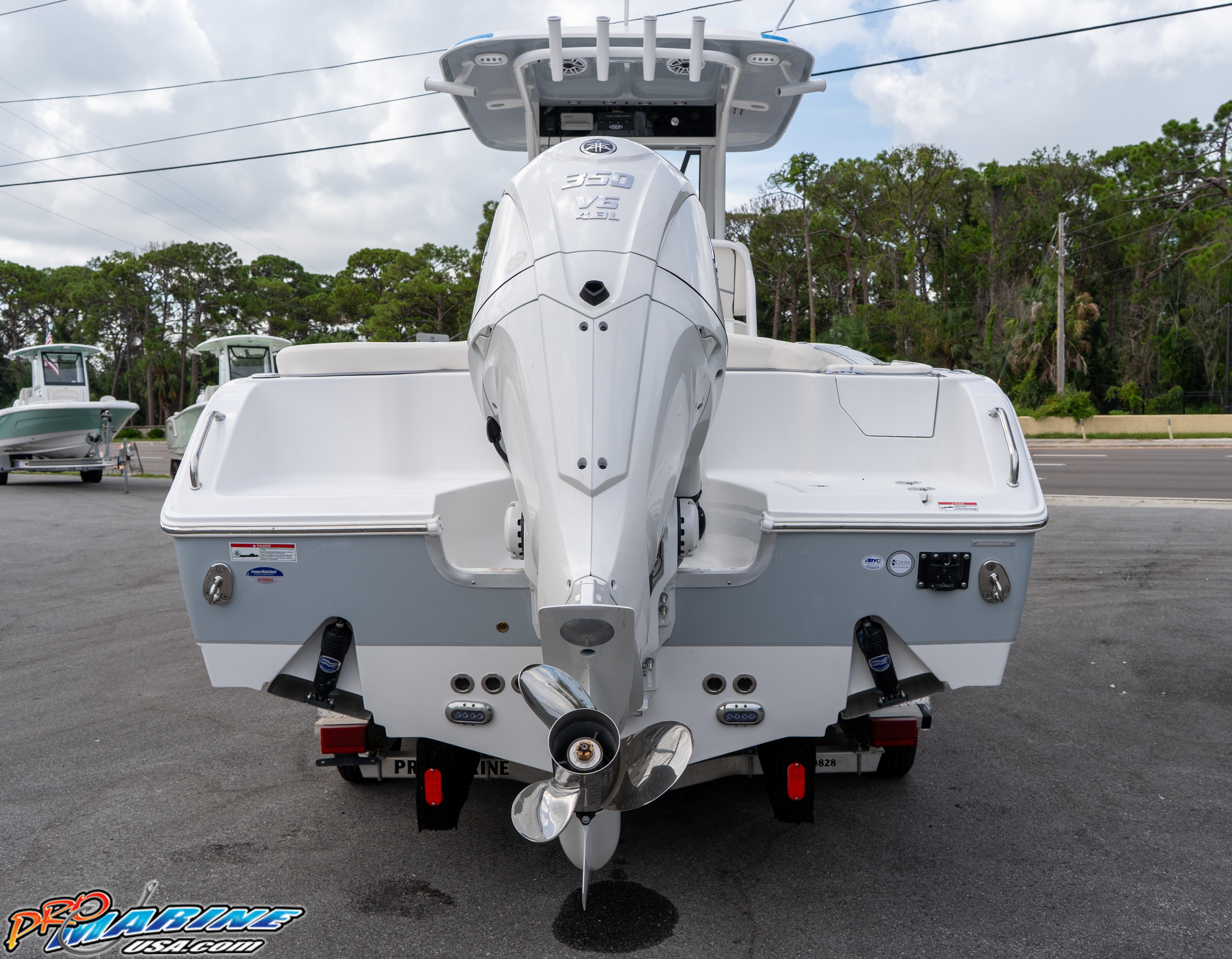 2026 Sea Hunt Ultra 255 SE boat with powerful outboard motor, parked outdoors.