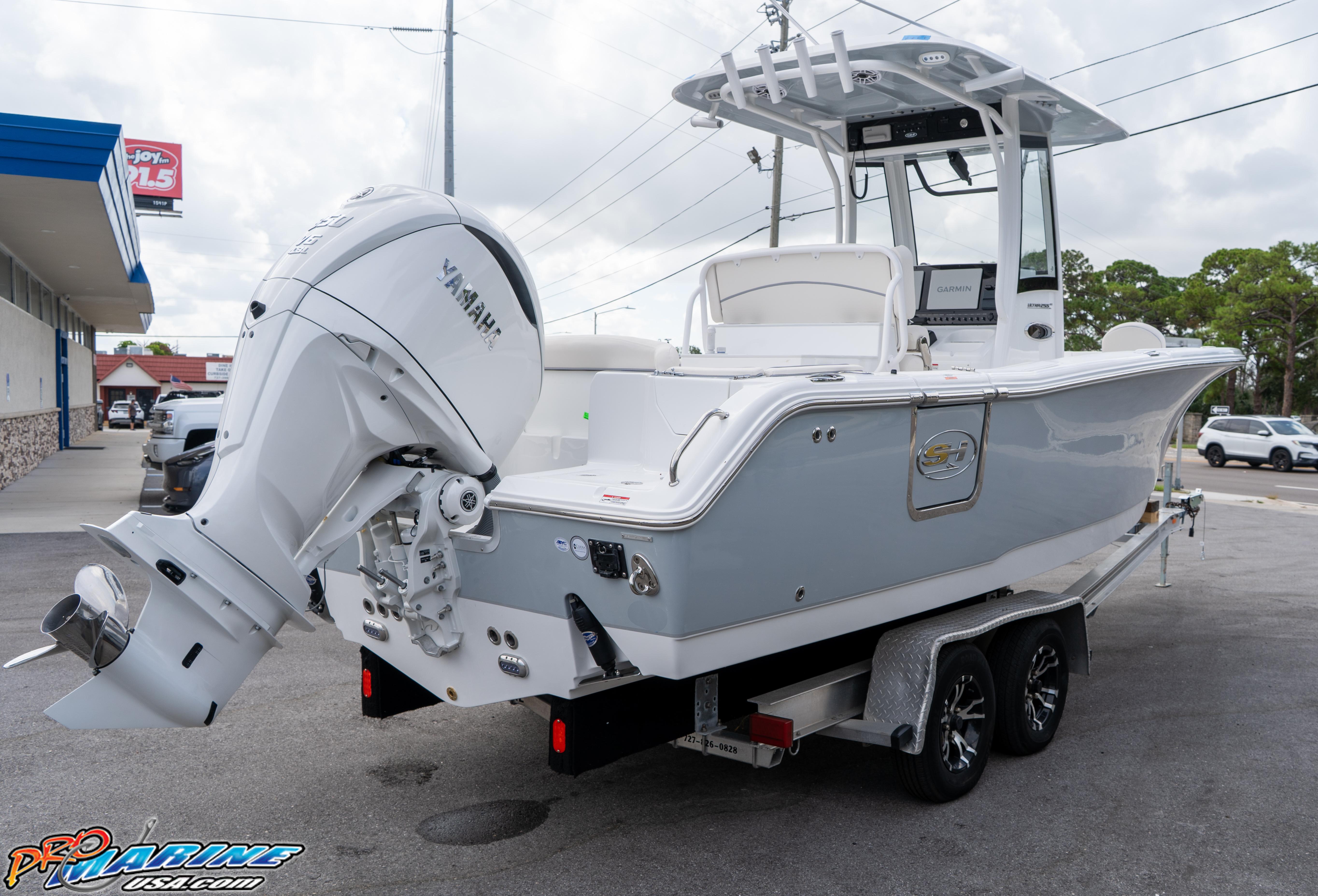 2026 Sea Hunt Ultra 255 SE boat on trailer with Yamaha engine, parked outdoors.