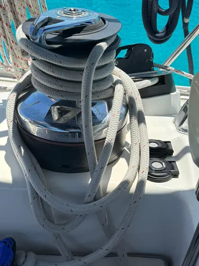  Yacht Photos Pics Sailboat winch with coiled rope on a 2005 Catalina 470, set against a clear blue sea.