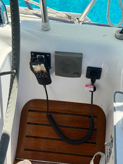  Yacht Photos Pics 2005 Catalina 470 sailboat cockpit with radio and speaker, overlooking clear blue water.