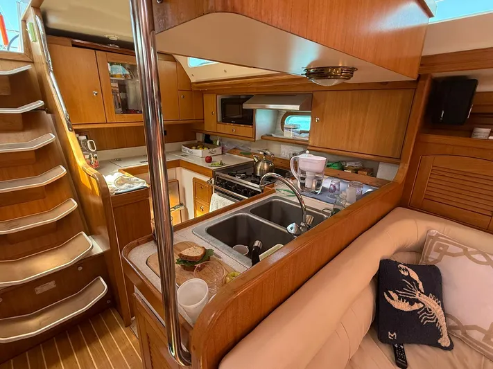  Yacht Photos Pics Interior of 2005 Catalina 470 yacht, featuring a cozy kitchen and seating area.