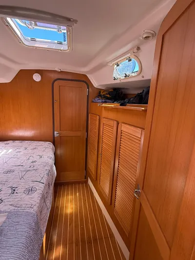  Yacht Photos Pics Interior of 2005 Catalina 470 sailboat with wooden cabinetry and cozy sleeping area.