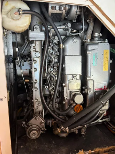  Yacht Photos Pics Engine compartment of a 2005 Catalina 470 sailboat, showcasing mechanical components and hoses.