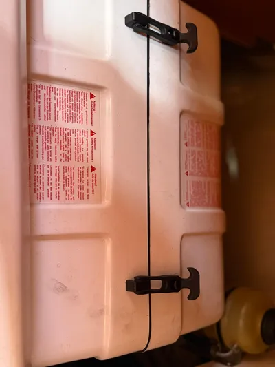  Yacht Photos Pics White storage container with black latches inside a 2005 Catalina 470 boat.