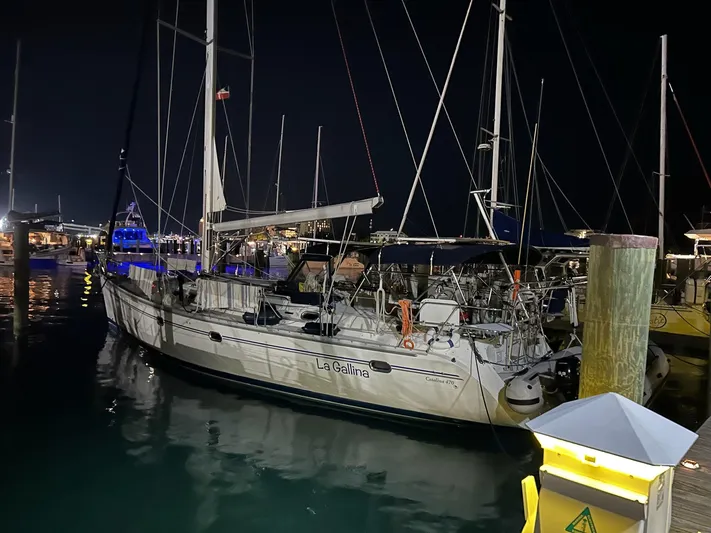  Yacht Photos Pics Catalina 470 sailboat docked at night, 2005 model, illuminated by marina lights.