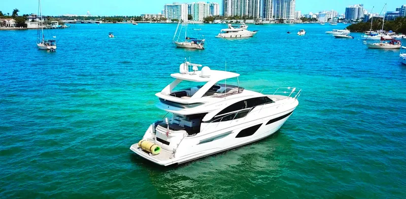 Balance Yacht Photos Pics Luxurious 2018 Princess F55 yacht cruising in vibrant blue waters near a cityscape.