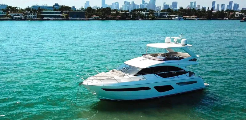 Balance Yacht Photos Pics Luxury 2018 Princess F55 yacht cruising on turquoise waters with city skyline backdrop.