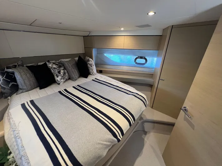 Balance Yacht Photos Pics Luxurious bedroom interior of 2018 Princess F55 yacht with striped bedding.