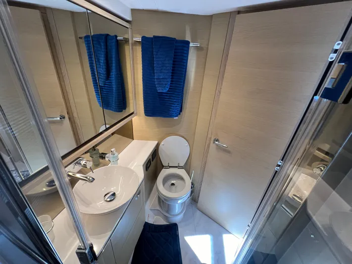 Balance Yacht Photos Pics Luxurious bathroom in 2018 Princess F55 yacht with modern fixtures and blue towels.