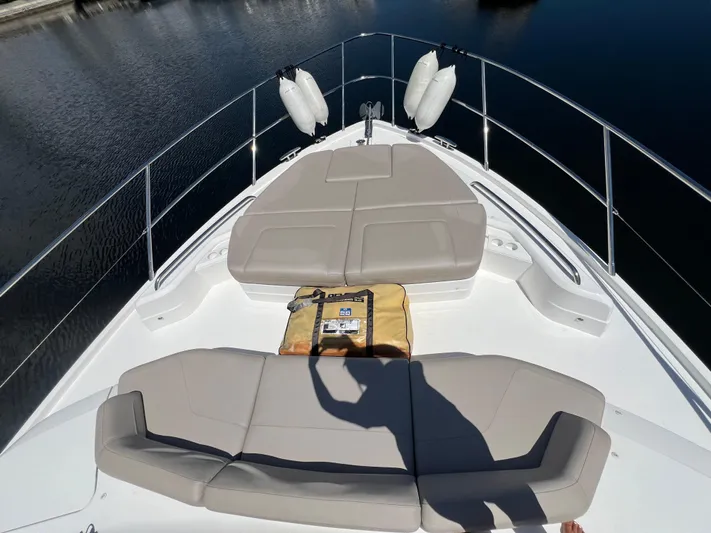 Balance Yacht Photos Pics 2018 Princess F55 yacht bow with cushioned seating and life raft.