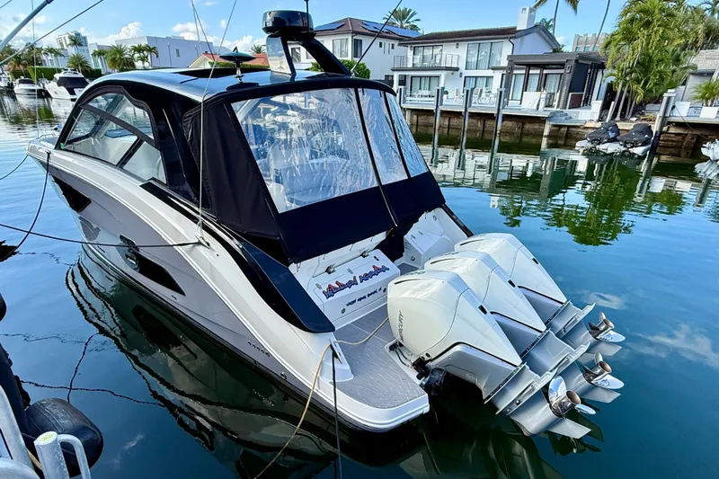  Yacht Photos Pics 2022 Sea Ray Sundancer 370 Outboard docked in a serene waterfront setting.