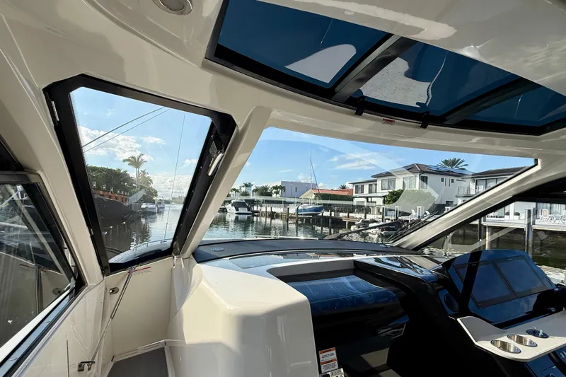  Yacht Photos Pics 2022 Sea Ray Sundancer 370 Outboard interior view with waterfront houses in background.