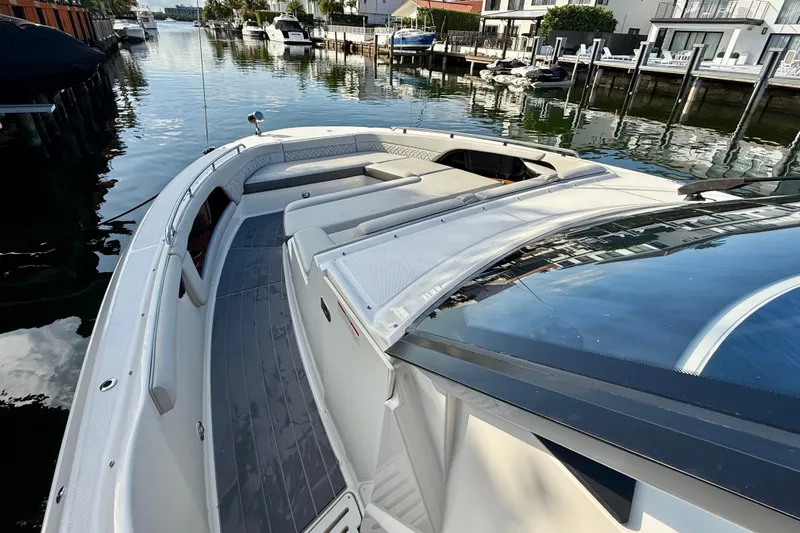  Yacht Photos Pics 2022 Sea Ray Sundancer 370 Outboard docked in a serene waterfront setting.