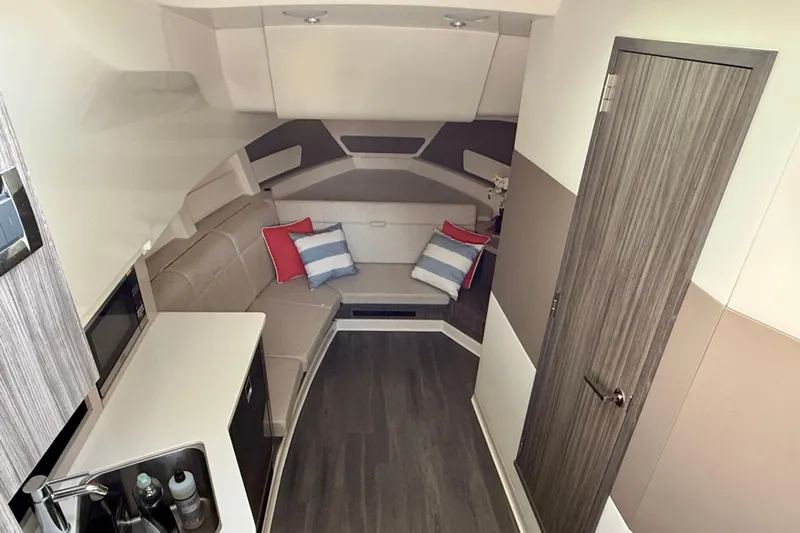  Yacht Photos Pics Interior of 2022 Sea Ray Sundancer 370 Outboard, featuring modern seating and compact kitchenette.