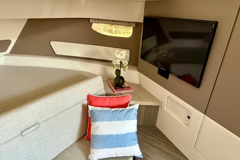  Yacht Photos Pics 2022 Sea Ray Sundancer 370 Outboard cabin interior with TV, cushions, and decor.