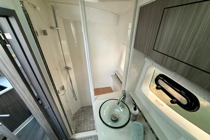  Yacht Photos Pics 2022 Sea Ray Sundancer 370 Outboard bathroom with modern shower and glass sink.