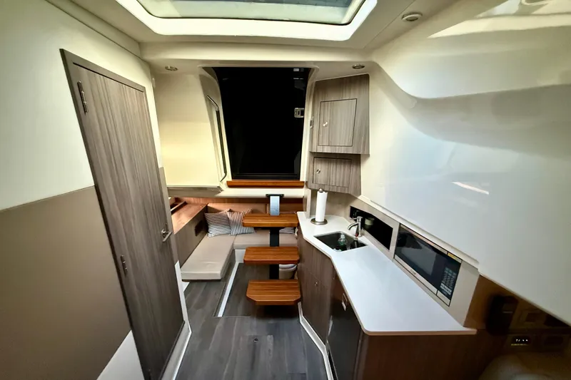  Yacht Photos Pics 2022 Sea Ray Sundancer 370 Outboard interior with modern kitchen and seating area.