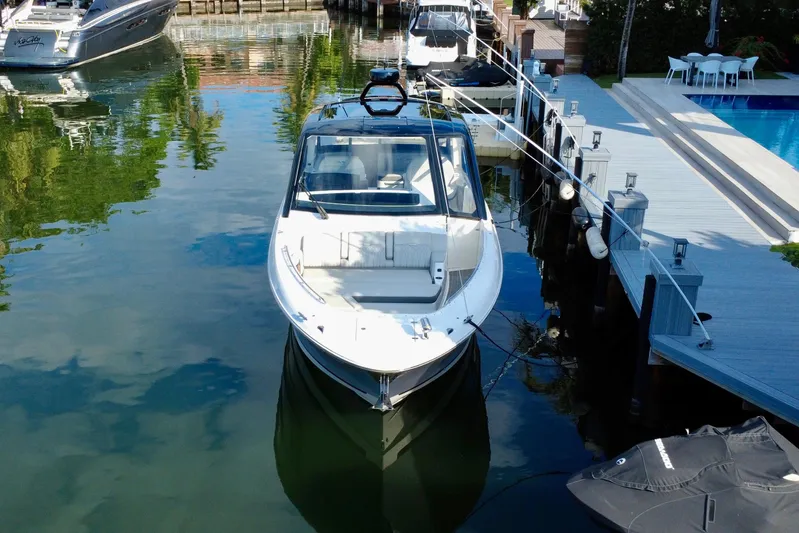  Yacht Photos Pics 2022 Sea Ray Sundancer 370 Outboard docked by a waterfront deck.