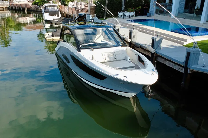 Yacht Photos Pics 2022 Sea Ray Sundancer 370 Outboard docked by a luxurious waterfront pool.