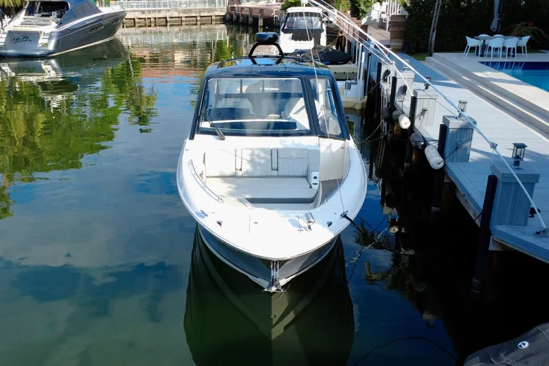  Yacht Photos Pics 2022 Sea Ray Sundancer 370 Outboard docked in a serene marina setting.