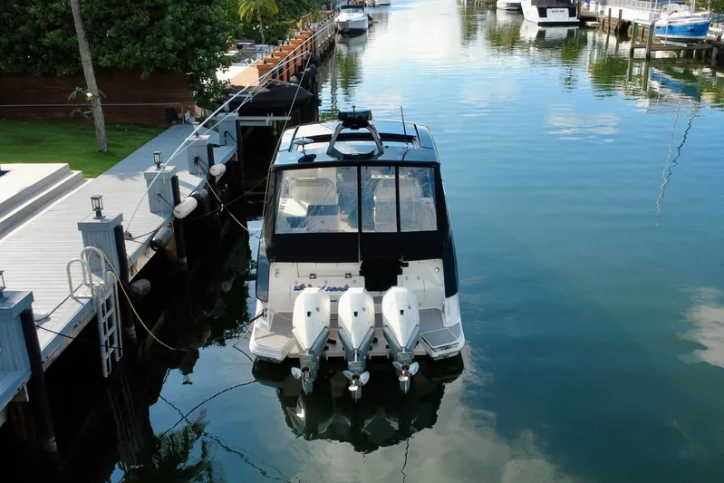  Yacht Photos Pics 2022 Sea Ray Sundancer 370 Outboard docked in a serene marina setting.