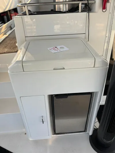 Musketeer Yacht Photos Pics 2000 Carver 406 Aft Cabin Motor Yacht interior with storage compartment and mini fridge.