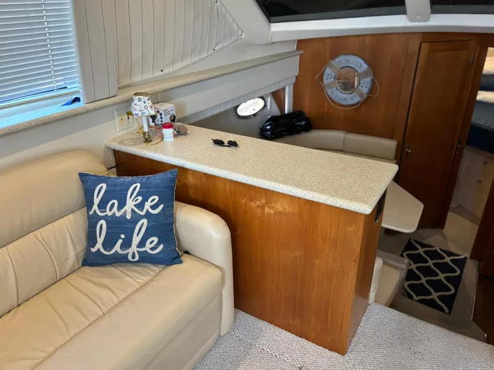 Musketeer Yacht Photos Pics Interior of 2000 Carver 406 Aft Cabin Motor Yacht with cozy seating and nautical decor.