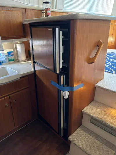 Musketeer Yacht Photos Pics 2000 Carver 406 Aft Cabin Motor Yacht interior with compact kitchen fridge.