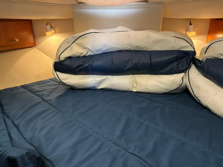Musketeer Yacht Photos Pics Cozy cabin interior of 2000 Carver 406 Aft Cabin Motor Yacht with blue bedding.