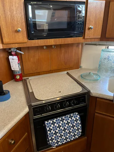 Musketeer Yacht Photos Pics Kitchen area in a 2000 Carver 406 Aft Cabin Motor Yacht with microwave and oven.