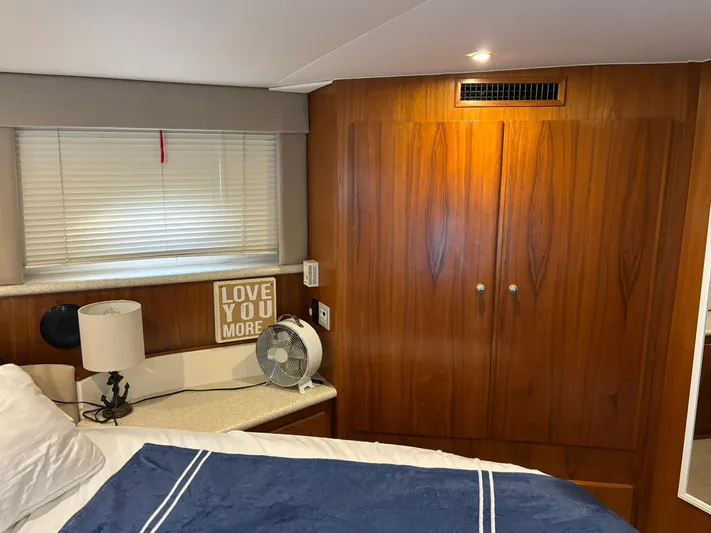 Musketeer Yacht Photos Pics Cozy cabin interior of 2000 Carver 406 Aft Cabin Motor Yacht with wood paneling and decor.