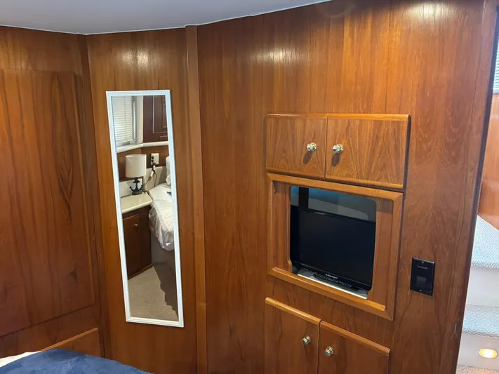 Musketeer Yacht Photos Pics Interior of 2000 Carver 406 Aft Cabin Motor Yacht with wood paneling and built-in TV.