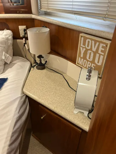 Musketeer Yacht Photos Pics Cozy cabin interior of 2000 Carver 406 Yacht with lamp and "Love You More" sign.