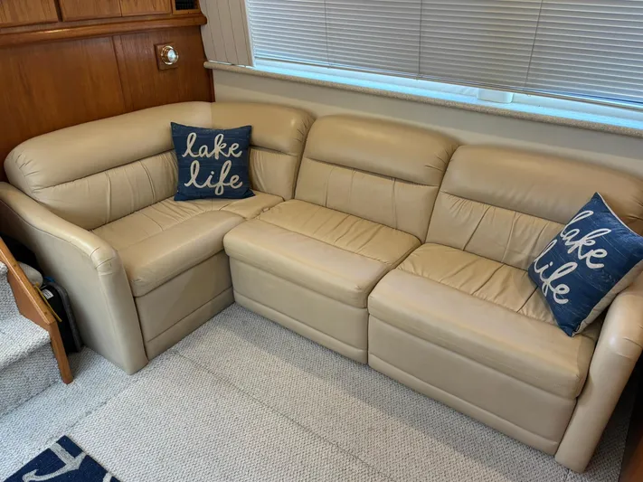 Musketeer Yacht Photos Pics Beige leather sofa with "lake life" pillows in Carver 406 Aft Cabin Motor Yacht, 2000.