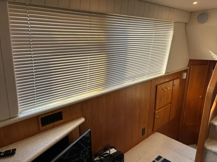Musketeer Yacht Photos Pics Interior of 2000 Carver 406 Aft Cabin Motor Yacht with blinds and wooden cabinetry.