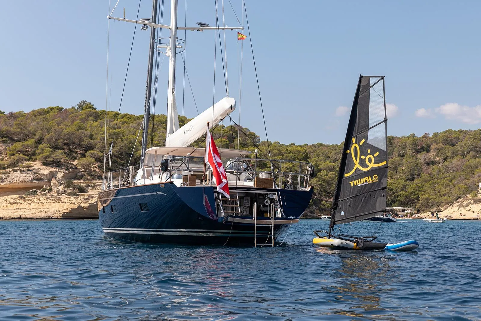 Sailing yacht by Steve Ward & Co, 2009 model, anchored near scenic coastline.
