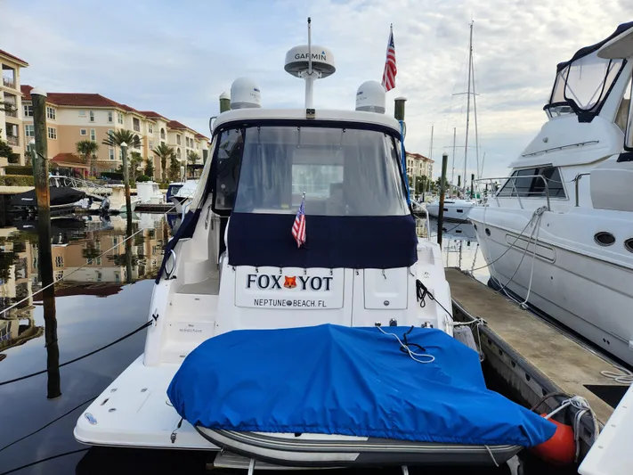Foxyot Yacht Photos Pics 2022 Regal 38 Grande Coupe docked at marina with American flags.