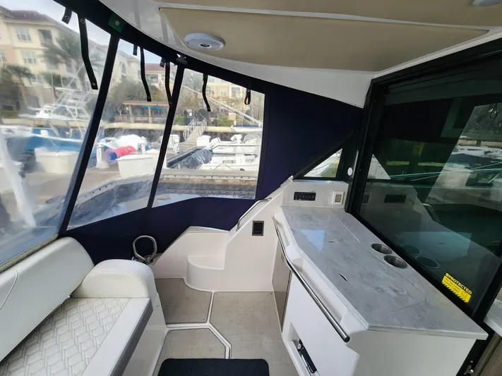 Foxyot Yacht Photos Pics Interior of 2022 Regal 38 Grande Coupe yacht with seating and counter.