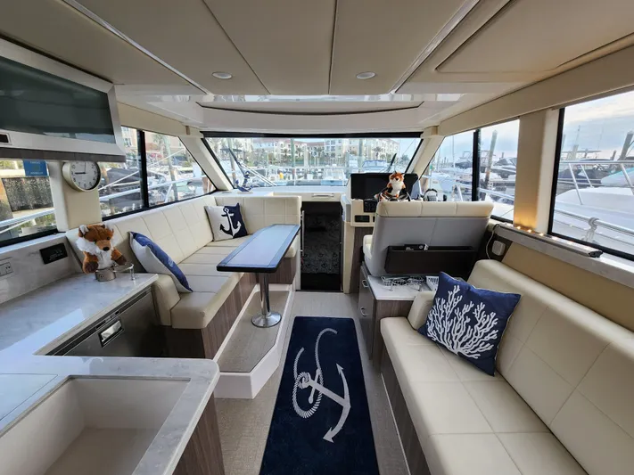 Foxyot Yacht Photos Pics Luxurious interior of 2022 Regal 38 Grande Coupe yacht with elegant seating and nautical decor.