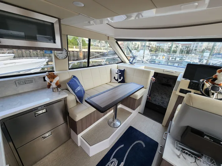 Foxyot Yacht Photos Pics Luxurious interior of 2022 Regal 38 Grande Coupe yacht with plush seating and modern amenities.
