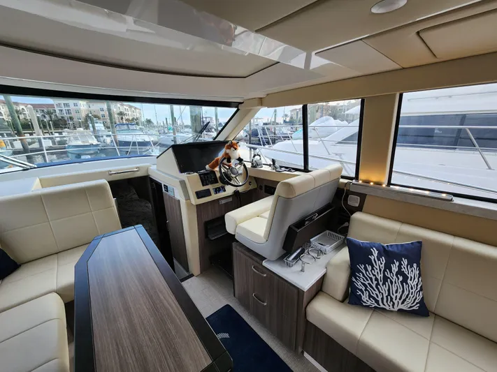 Foxyot Yacht Photos Pics Interior of 2022 Regal 38 Grande Coupe yacht with modern seating and helm.