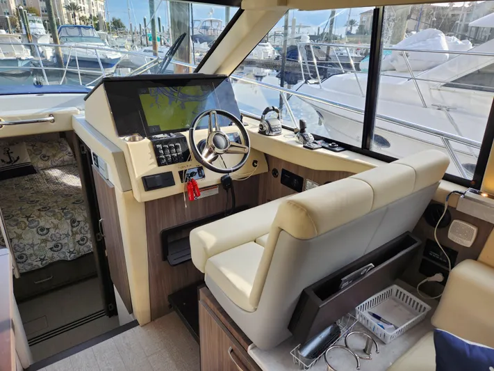 Foxyot Yacht Photos Pics Interior of 2022 Regal 38 Grande Coupe yacht, featuring modern helm and navigation equipment.
