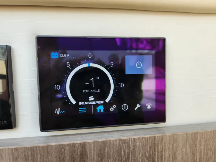 Foxyot Yacht Photos Pics Seakeeper control panel on 2022 Regal 38 Grande Coupe, displaying roll angle and battery voltage.